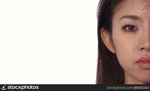 Real Asian people portrait with emotions and feelings. Close-up of face on white background. Beautiful young depressed Japanese woman, sad lady, anxious pretty girl looking at camera. Sadness, anxiety