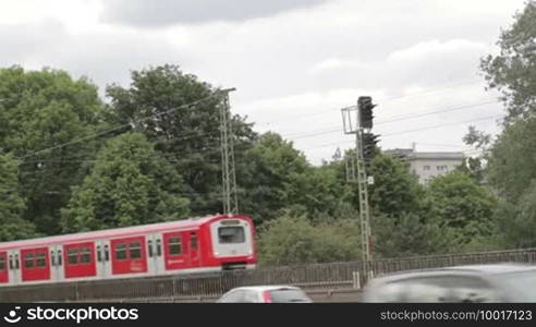 Red train on the bridge passes by in Hamburg, Germany