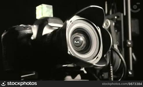 Remote hot head camera crane closeup in dark studio