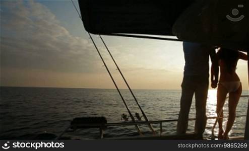 Romantic Couple Silhouette on Yacht at Sunset