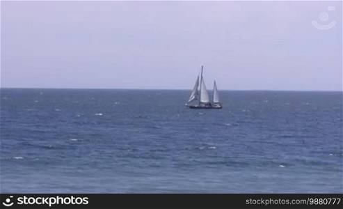 Sailing yacht in sea.