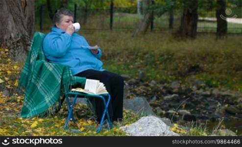 Senior woman drinking coffee, side view