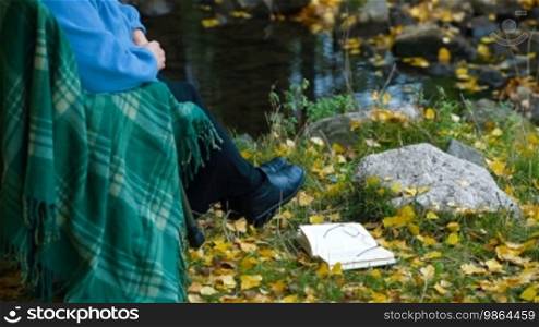 Senior Woman with Book in Autumn Park, Unrecognizable Person, Side View