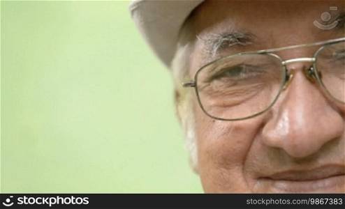 Seniors portrait of happy elderly man with white hat and glasses looking at camera. Sequence