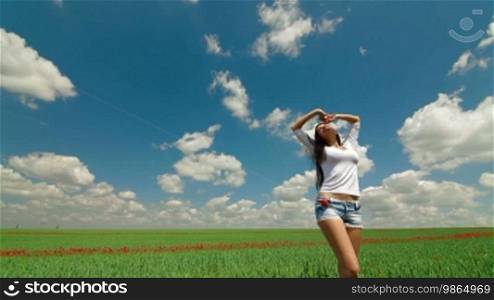Sexy Young Woman Enjoying Summer Day In A Green Wheat Field. Tracking shot