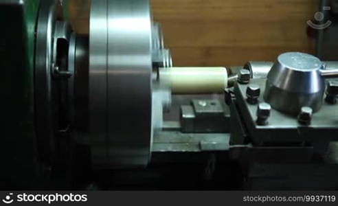 Side view of drilling and turning mold part of old turning lathe machine.