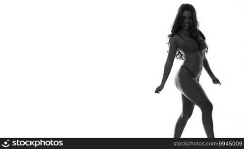 Silhouette of a sexy dancing woman in lingerie