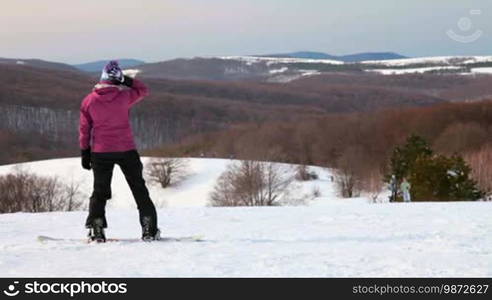 Snowboarder getting ready to descend from the mountain Ai-Petri, Crimea