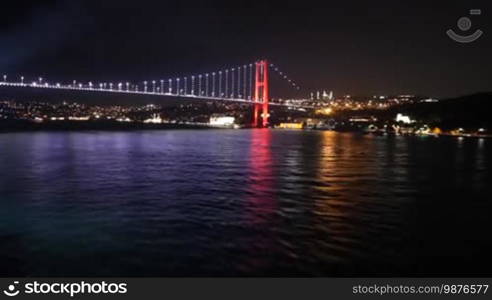 Spectacular view from a boat sailing away from Istanbul's bridge at night