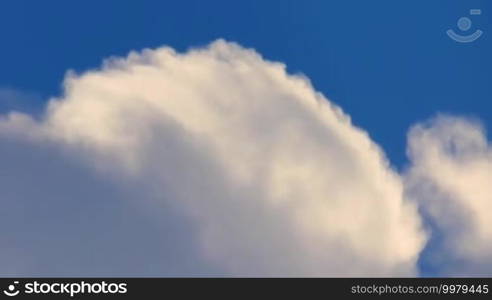 Swirling white clouds on a background of deep blue sky