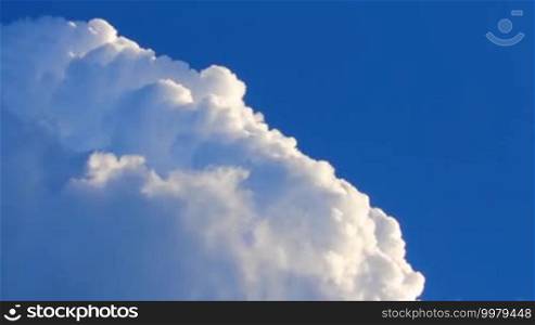 Swirling white clouds on a background of deep blue sky