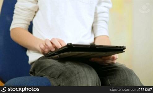 Teen Boy Using a Touch Screen Tablet PC