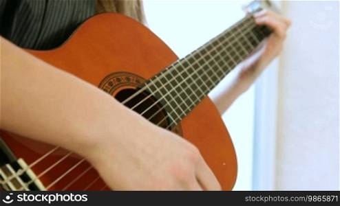 Teen Girl Playing Guitar Close-up