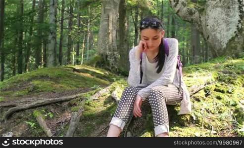 Teenage girl tourist enjoying the nature in the forest.