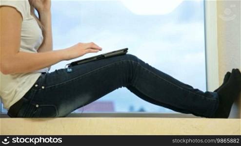 Teenager Girl Listening to Music on Digital Tablet at Home