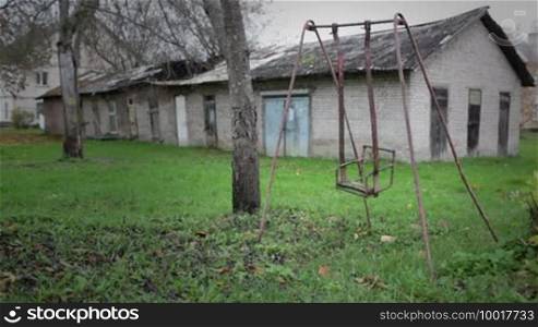 The broken child's swing. Unhappy childhood concept.