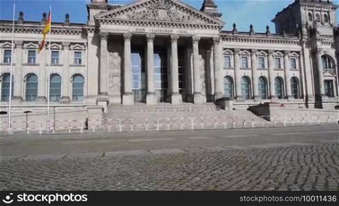 The German Parliament building Reichstag without people but with an exclusion zone, tracked from bottom to top, Das deutsche Parlament, der Reichstag in Berlin, empty and with barriers, panning from bottom to top