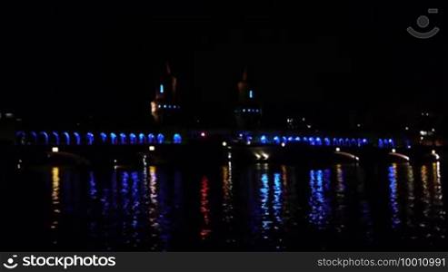 The Oberbaum Bridge near the East Side Gallery in New Berlin at the Festival of Lights 2010 with the blue illumination and reflections in the River Spree in front