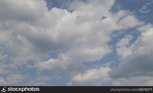 Time lapse clip of white fluffy clouds over blue sky