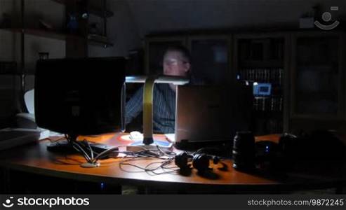 Time lapse. Man works on computer at night.