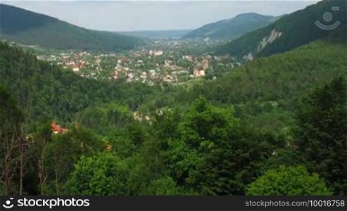 Time lapse of Carpathian Mountains and small village between, panorama