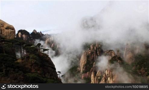 Time lapse of clouds crossing over mountain in China.