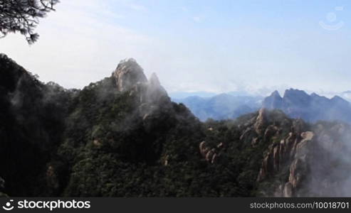 Time lapse of clouds crossing over mountain in China.