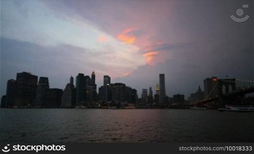 Time-lapse of New York City Skyline (South Street Seaport) at stormy weather, from dusk to night