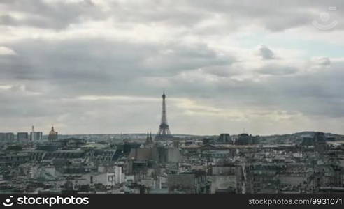 Timelapse shot of clouds piling up over Paris as the evening comes. Panoramic shot of the city with the Eiffel Tower in center