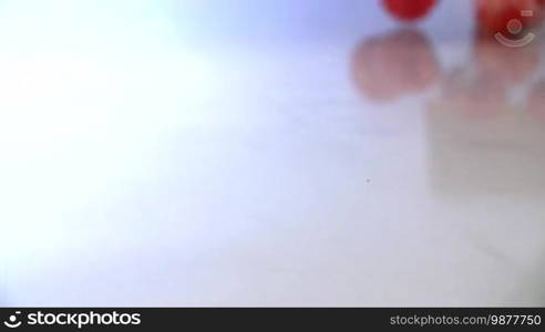 Tomatoes Falling in Slow Motion in water. Shot in 200 fps