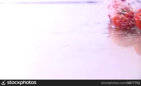 Tomatoes Falling in Slow Motion in water. Shot in 200 fps