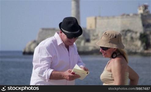 Tourism and active retirement with elderly people traveling, senior couple having fun on holidays in Havana, Cuba. Sequence
