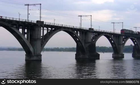 Train crossing a modern style bridge.