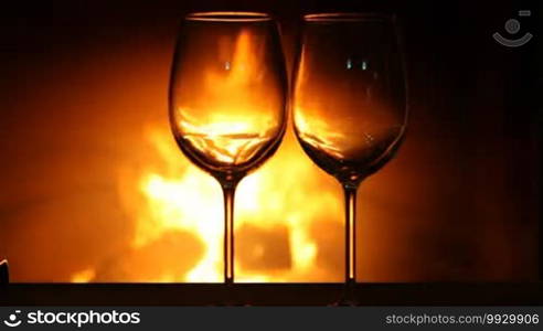 Two wineglasses near fireplace