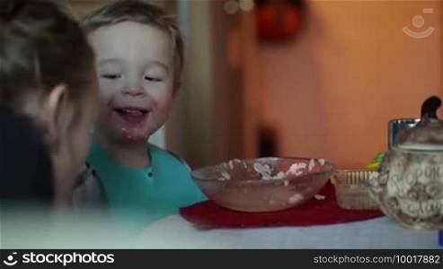 Two-year-old boy is eating fish soup from the plate. Clip three.