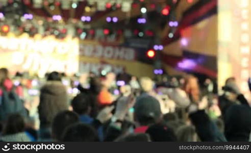 Unidentified music fans record the show