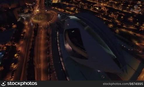 VALENCIA, SPAIN - JULY 16, 2016: Flying over entertainment-based cultural and architectural complex City of Arts and Sciences at night