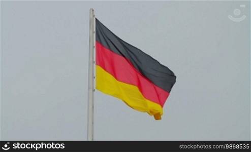 Video shot of German flag flapping with sky background