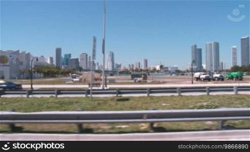 View of the skyline of Miami shot from a car with traffic in the foreground