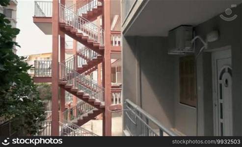 View to the apartment balcony and to outdoor stairways of the next hotel building