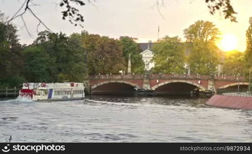 Vintage ferry with people on the German river in Berlin