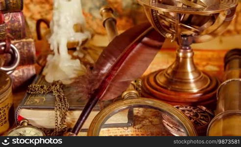 Vintage still life. Vintage magnifying glass lies, pocket watch, old book and astrolabe on an ancient world map in 1565.