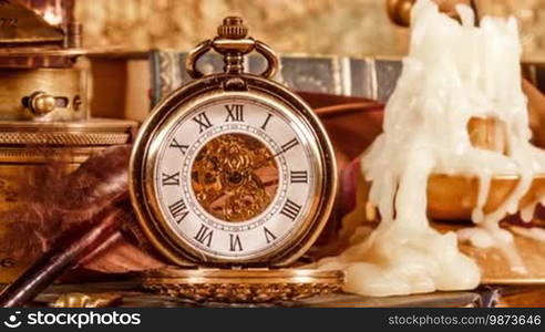 Vintage still life. Vintage magnifying glass lies, pocket watch, old book and astrolabe on an ancient world map in 1565.