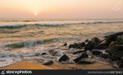 Waves and foam on rocky beach Indian Ocean