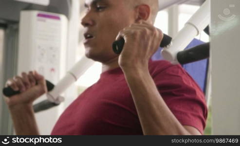 Wellness and training in fitness club, Hispanic man exercising in gym. Sequence