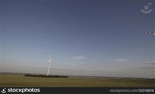 Wind energy turbines with windmills in the horizon