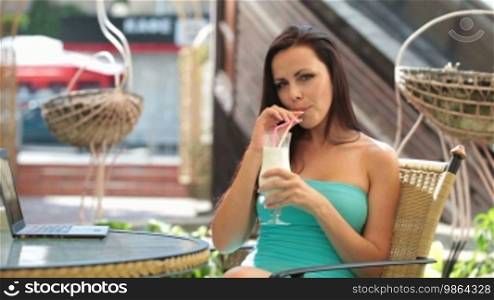 Woman in a restaurant drinking milkshake