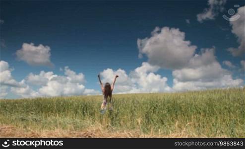 Woman in Wheat Field With Arms Outstretched