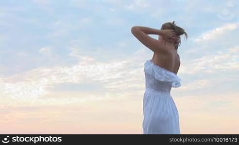 Woman in white dress on the beach