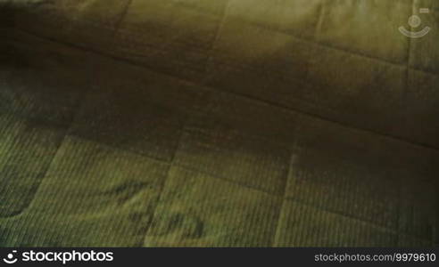 Woman putting a pile of clean white towels on the bed and smoothing it with hands